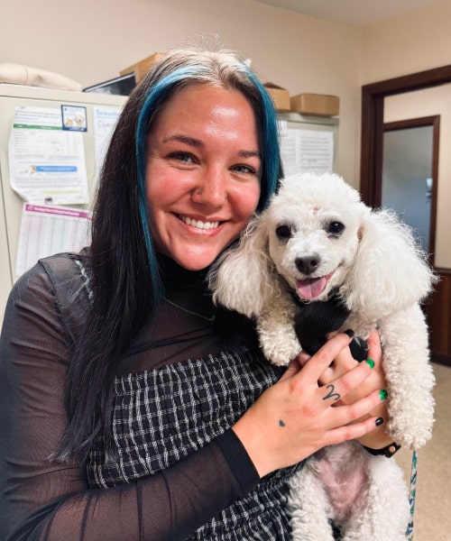 Sarah holding a cute fluppy dog in her hands